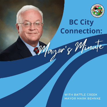 Mayor Mark Behnke official head shot on blue background, with dark blue wave