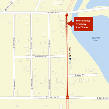 A city street map showing the temporary road closure of Riverside Drive as a red line.
