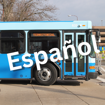 Front side of a blue city bus with Español text overlay