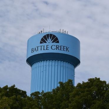 Top of blue Fort Custer Battle Creek water tower, with city name and wheat design on it