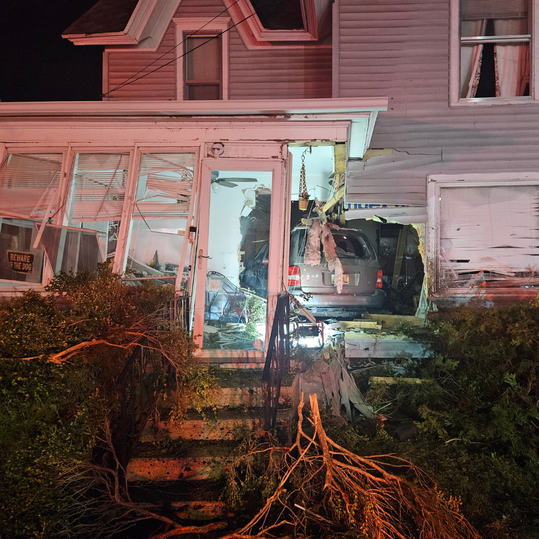 A silver minivan is partially embedded in front of a house on Upton Avenue on Friday, April 11.