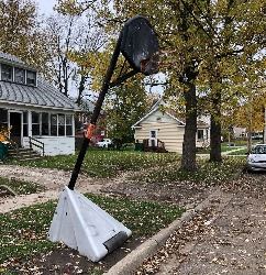 Street basketball hoop tagged with removal notice